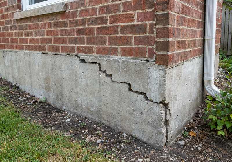 Cracked, settling foundation wall before repair at a Greenville, SC home